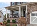Inviting front porch features stone accents and space to sit and relax at 464 Granite Saddle Dr, Rolesville, NC 27571
