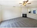 Cozy living room features a fireplace, neutral carpet and a breakfast bar overlooking the kitchen at 5107 Tomasita Ct, Raleigh, NC 27616