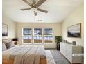 Bright main bedroom featuring a ceiling fan, three large windows, and modern decor at 5107 Tomasita Ct, Raleigh, NC 27616