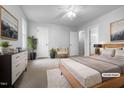 Bright bedroom featuring a ceiling fan, soft carpet, and a cozy, neutral color palette at 516 Caprice Ct, Raleigh, NC 27606