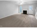 A large, empty living room with light-colored walls and carpet at 516 Caprice Ct, Raleigh, NC 27606