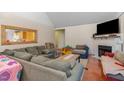 Living room featuring a fireplace, large windows and plush couches at 589 Vinson Rd, Clayton, NC 27527