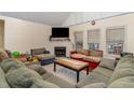 Living room featuring a fireplace, large windows and plush couches at 589 Vinson Rd, Clayton, NC 27527