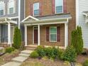 Inviting front porch with red brick and colorful landscaping at 5908 Giddings St, Raleigh, NC 27616