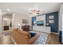 Cozy living room with hardwood floors, blue accent wall and comfortable seating area at 5908 Giddings St, Raleigh, NC 27616