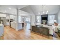 Open concept living room and kitchen with hardwood floors, stainless appliances, and lots of natural light at 67 Rice Road # 01, Zebulon, NC 27597