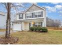 Traditional two-story home with a front-facing garage and well-maintained lawn at 702 Blue Lake Dr, Mebane, NC 27302
