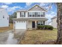 Lovely two-story home with a stone-accented garage and a well-kept lawn at 702 Blue Lake Dr, Mebane, NC 27302