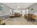 Cozy living room with plush seating, a ceiling fan, and neutral color palette at 702 Blue Lake Dr, Mebane, NC 27302