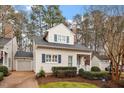 Quaint two-story home with attached garage, blue shutters, and landscaped front yard at 800 Mill Greens Ct, Raleigh, NC 27609