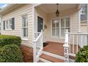 Welcoming front porch with a 'hello' mat, white railings, and natural light at 800 Mill Greens Ct, Raleigh, NC 27609