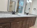 Bathroom showcasing double vanity with dark wood cabinets and granite countertops at 812 Kenmore Ave, Louisburg, NC 27549