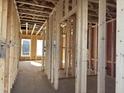 Interior framing featuring the raw construction and exposed wood, showcasing the layout of the future rooms at 88 Windchime Ct, Fuquay Varina, NC 27526