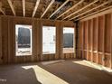 Wood-framed interior with natural light streaming through window openings showcasing the house under construction at 88 Windchime Ct, Fuquay Varina, NC 27526
