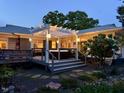 Backyard deck featuring hot tub with pergola and stone details at 1005 W Club Blvd, Durham, NC 27701