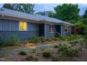 Charming home featuring a stone walkway, updated exterior, lush landscaping, and inviting curb appeal at 1005 W Club Blvd, Durham, NC 27701