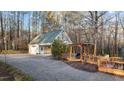 Large detached garage with a connected pergola and gravel driveway at 151 Cheyenne Dr, Louisburg, NC 27549