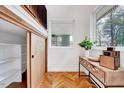 Stylish entryway with hardwood floors, bright white walls, and a glimpse of the storage area at 1604 Malta Ave, Raleigh, NC 27610