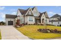 Charming two-story home with a driveway leading to a garage and a well-maintained lawn at 1804 Clifton Pines Dr, Cary, NC 27519