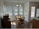 Bright breakfast nook featuring a round table, wood chairs, and natural light from the surrounding windows at 1811 Kelly Glen Dr, Apex, NC 27502