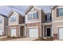 Attractive townhouse showcasing a stone and siding exterior with a one-car garage at 1912 Frost Dr, Haw River, NC 27258
