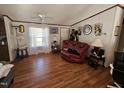 Comfortable living room features hardwood floors and a cozy seating area at 2020 Sanders Rd, Stem, NC 27581