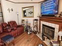 Cozy living room featuring a fireplace and a comfortable recliner at 2020 Sanders Rd, Stem, NC 27581
