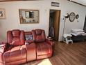 Comfortable living room featuring a recliner and laminate wood flooring at 2020 Sanders Rd, Stem, NC 27581
