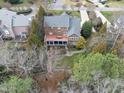 Aerial view of a home featuring a two-level deck, lush landscaping and mature trees at 204 Brittany Pl, Cary, NC 27511