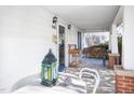 Cozy covered front porch with a table, chairs, and a porch swing at 2606 W Knox St, Durham, NC 27705