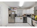Functional kitchen featuring stainless steel refrigerator, white cabinets and granite countertops at 2732 Old Milburnie Rd, Raleigh, NC 27604