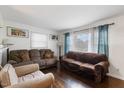 Bright living room featuring hardwood floors, natural light, and comfortable seating at 2732 Old Milburnie Rd, Raleigh, NC 27604