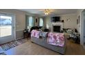 Cozy living room features a fireplace, neutral paint colors, and lots of space at 305 River Birch Run, Coats, NC 27521