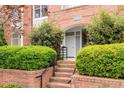 Close up of the front entrance, with brick steps, manicured hedges and door to 401 Thompson St at 401 Finsbury St # 301, Durham, NC 27713
