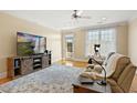 Bright living room with hardwood floors, a large TV, and a comfortable reclining sofa at 401 Finsbury St # 301, Durham, NC 27713