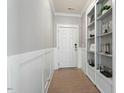 Inviting entryway features wood-look tile floors, board and batten accent wall, and built-in shelving at 456 Highview Dr, Benson, NC 27504