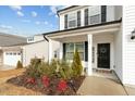 Inviting front porch with manicured landscaping and a black front door at 456 Highview Dr, Benson, NC 27504