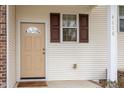 Exterior view of front door with brown door with glass and brown shutters at 4618 Pooh Corner Dr, Raleigh, NC 27616