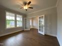 Bright office space featuring hardwood floors, elegant French doors, and a ceiling fan for added comfort at 4881 Grosbeak Ct, Mebane, NC 27302