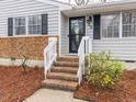 A close-up of the front door with brick stairs and fresh landscaping at 512 Trail Of Merlin, Garner, NC 27529