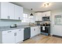 Kitchen featuring stainless steel appliances, granite countertops, and white cabinets at 512 Trail Of Merlin, Garner, NC 27529