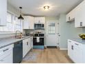Well-lit kitchen featuring stainless steel appliances, granite countertops, and stylish light fixture at 512 Trail Of Merlin, Garner, NC 27529
