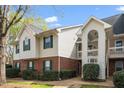 Townhouse exterior with brick and siding, green shutters, and a covered entrance creates curb appeal at 521 Renshaw Ct, Cary, NC 27518
