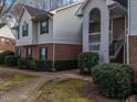 Traditional condo building with hardiplank siding, brick accents, and manicured bushes at 521 Renshaw Ct, Cary, NC 27518