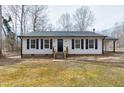 Lovely single-story home with tidy front yard, black shutters and door at 5635 Paragon Cir, Durham, NC 27712