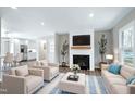 Bright, open-concept living room with fireplace, plush seating, and hardwood floors perfect for relaxation at 5635 Paragon Cir, Durham, NC 27712
