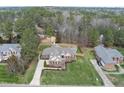 Expansive brick home with manicured lawn and mature trees in established neighborhood at 6 Kersey Ct, Durham, NC 27713
