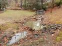 Picturesque backyard featuring a rock-lined stream with a small bridge, perfect for relaxing at 621 Chalice St, Durham, NC 27705