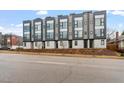 Modern townhomes feature sleek lines, large windows, and neutral color palette, with professionally landscaped front yards at 712 E Edenton St # 102, Raleigh, NC 27601
