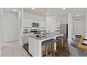 Modern kitchen featuring white cabinets, granite countertops, stainless steel appliances and island with seating at 7369 Pilatus Ave, Spring Hope, NC 27882